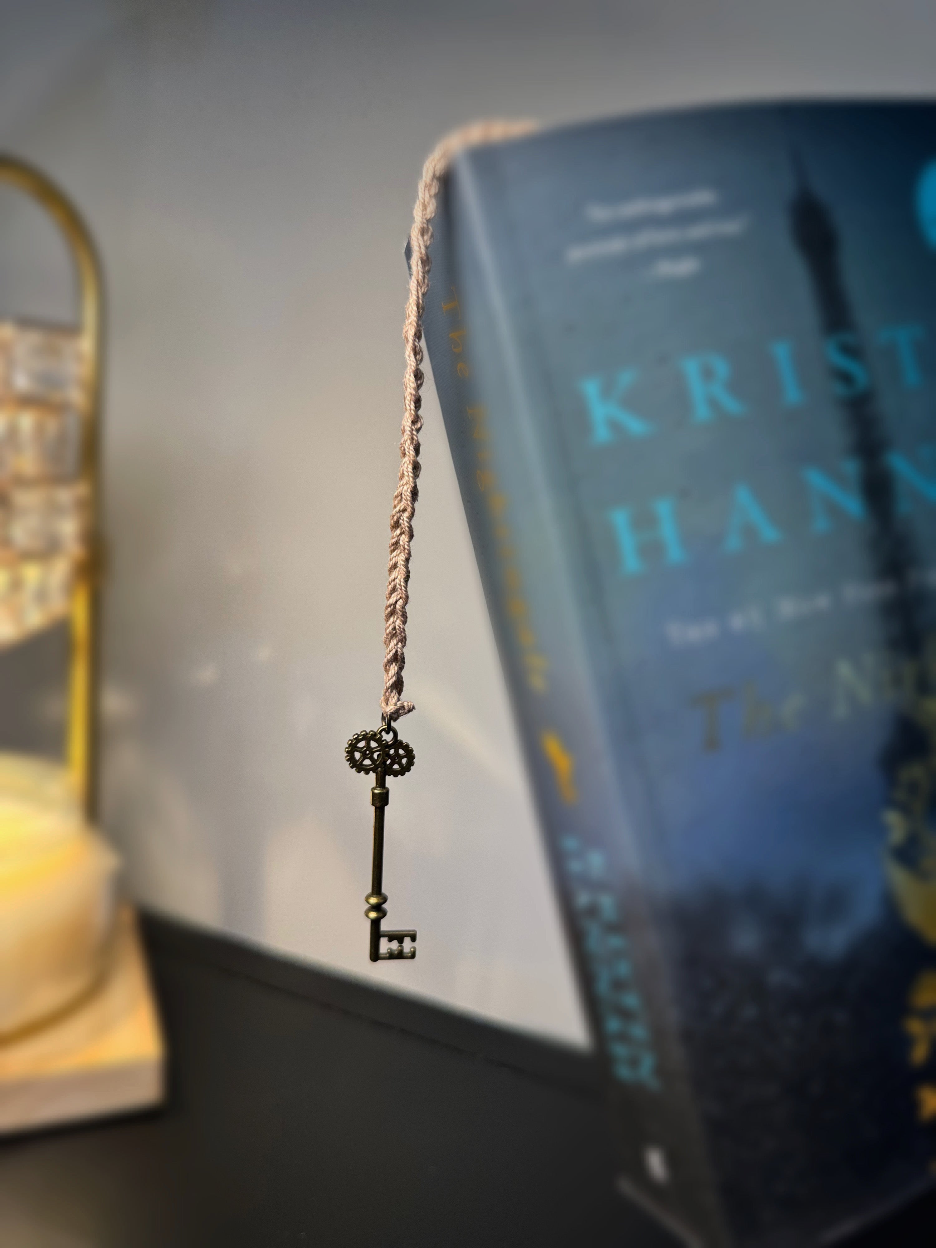 Brown Handmade Crochet Bookmark with Key Charm Dangling from Book